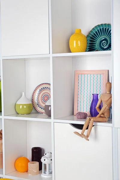 Beautiful white shelves with different home objects — Stock Photo, Image