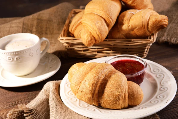 Delicious croissants on plate on table close-up — Stock Photo, Image