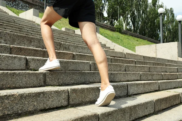 Young man jogging at stairs — Stock Photo, Image