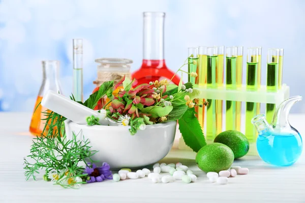 Herbs in mortar, test tubes — Stock Photo, Image