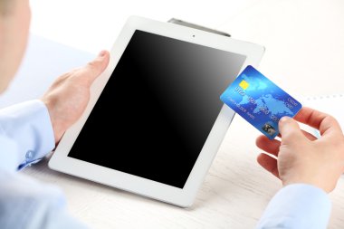 Kredi kartı ve tablet işyeri arka planda tutan adam