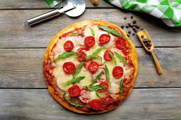 Delicious pizza with cheese and cherry tomatoes on wooden table, top view — Stock Photo, Image