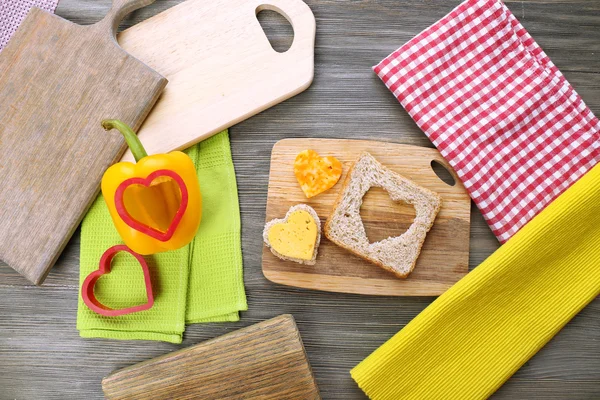 Fatia de pão com corte em forma de coração e pimenta na mesa de perto — Fotografia de Stock