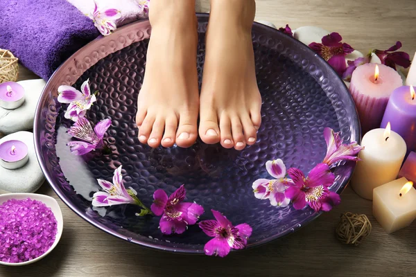 Female feet at spa pedicure procedure