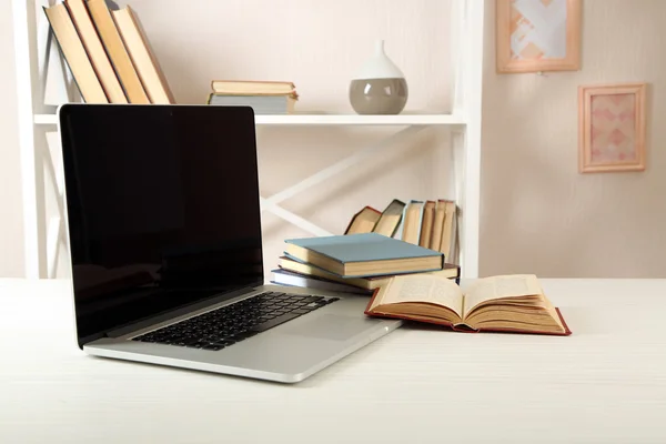 Ordinateur portable avec livres sur table dans la chambre — Photo