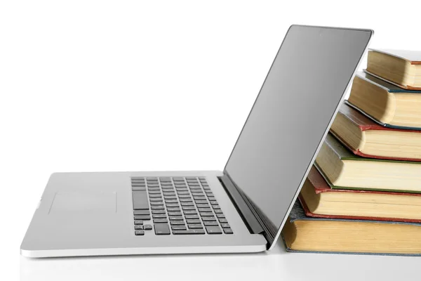 Stack of books with laptop isolated on white — Stock Photo, Image