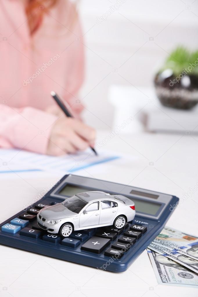 Toy car and documents on table. Car insurance concept