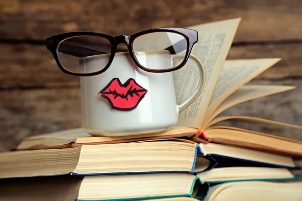 Books and cup with lips — Stock Photo, Image