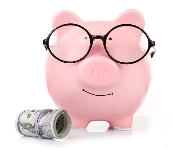 Piggy bank in glasses with dollars isolated on white — Stock Photo, Image