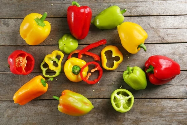 Colorful peppers on rustic wooden table — Stock Photo, Image