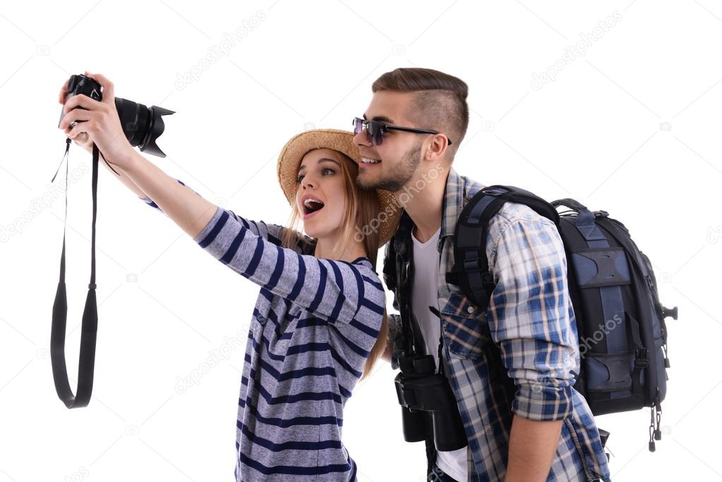 Pair of travelers with camera isolated on white