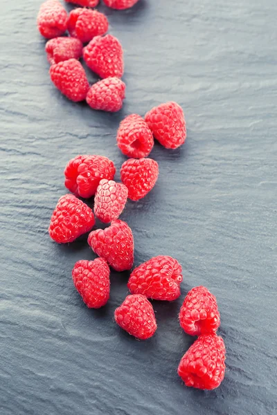 Red sweet raspberries on wooden table close up — Stock Photo, Image
