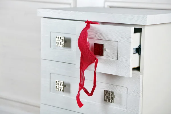 White wooden chest of drawer with bra in opened drawer — Stock Photo, Image