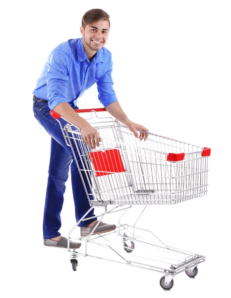 Young man with empty shopping cart, isolated on white — Stock Photo, Image