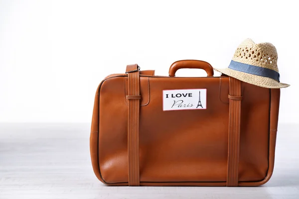 Suitcase with stickers on floor — Stock Photo, Image