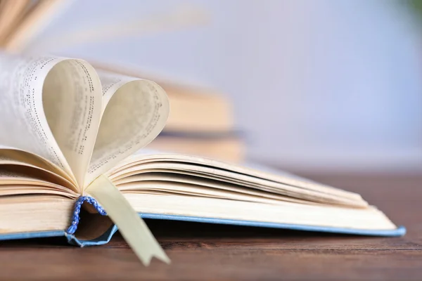 Pages of book curved into heart shape — Stock Photo, Image