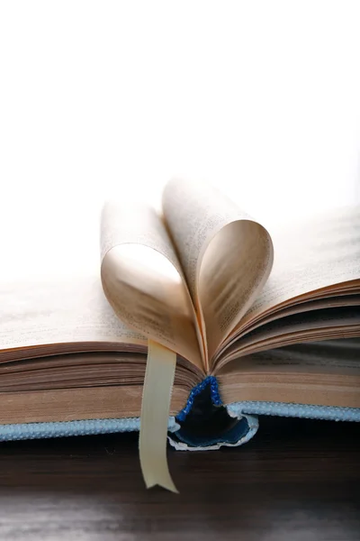 Pages of book curved into heart shape — Stock Photo, Image