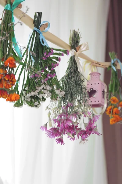 Herbs and flowers drying on thong — Stock Photo, Image