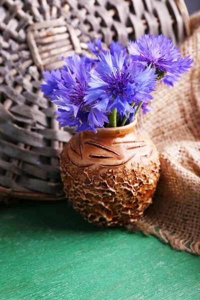 Beautiful cornflowers in vase on wooden background — Stock Photo, Image