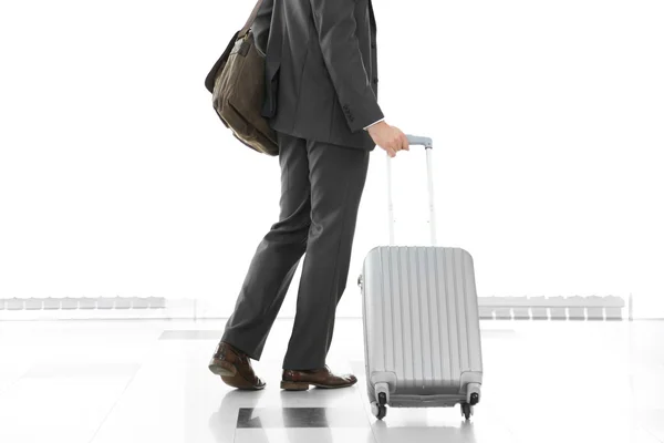 Άνθρωπος που κρατά την βαλίτσα επάνω ελαφρύς υπόβαθρο — Φωτογραφία Αρχείου