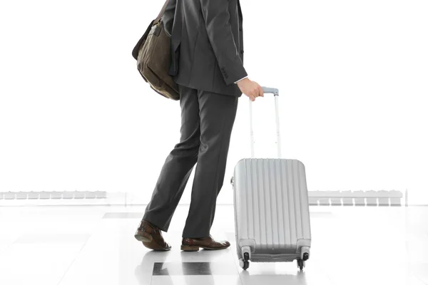 Man holding suitcase on light background — Stock Photo, Image