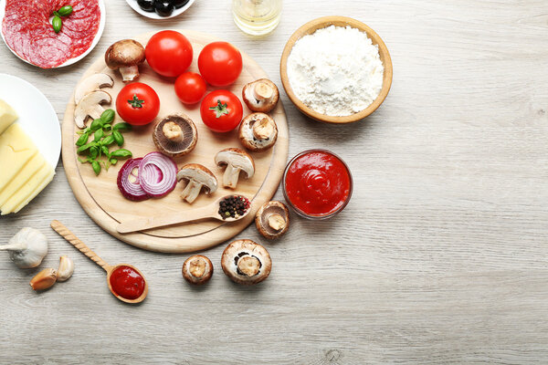 Ingredients for cooking pizza on wooden table, top view