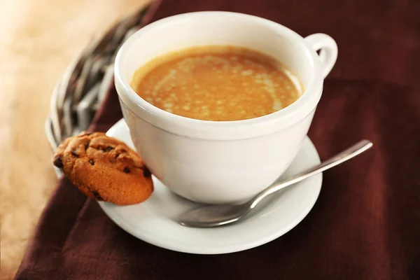 Cup of coffee with cookie on table, closeup — Stock Photo, Image