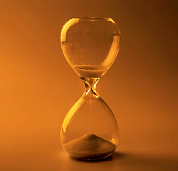 Hourglass on color background — Stock Photo, Image