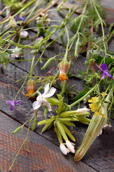 Wildflowers on wooden table, closeup — Stock Photo, Image