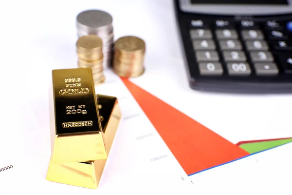 Gold bullion with coins on documents background