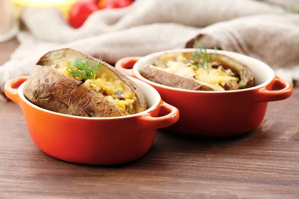 Baked potatoes with cheese and mushrooms on table close up — Stock Photo, Image