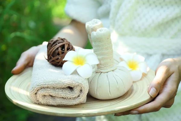 Female hands with tray of spa products — Stock Photo, Image