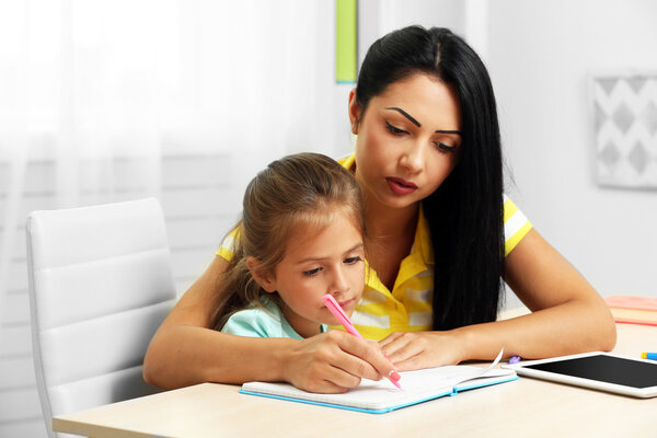 Beautiful school girl doing homework