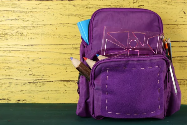 School backpack on wooden background — Stock Photo, Image