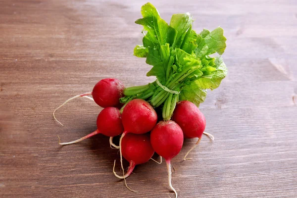 Bunch of radishes on wooden background — Stock Photo, Image
