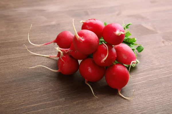 Bunch of radishes on wooden background — Stock Photo, Image