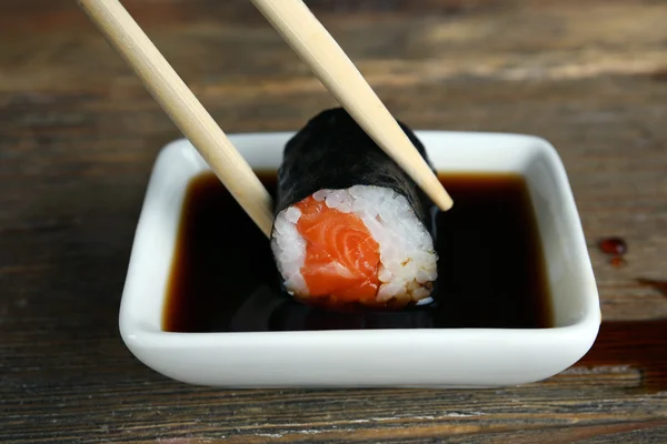 Dipping roll in sauce — Stock Photo, Image