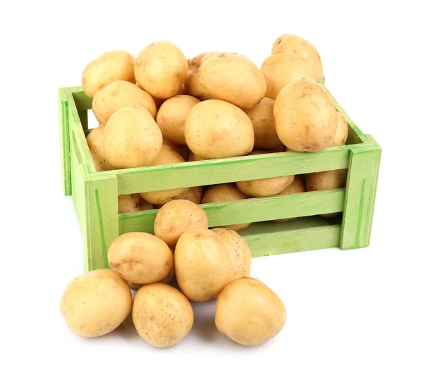 Nové brambory v dřevěný stůl izolovaných na bílém — Stock fotografie