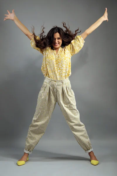 Young woman dressed in retro style on grey background Stock Image