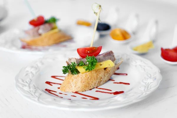 Tasty canapes on wooden table — Stock Photo, Image