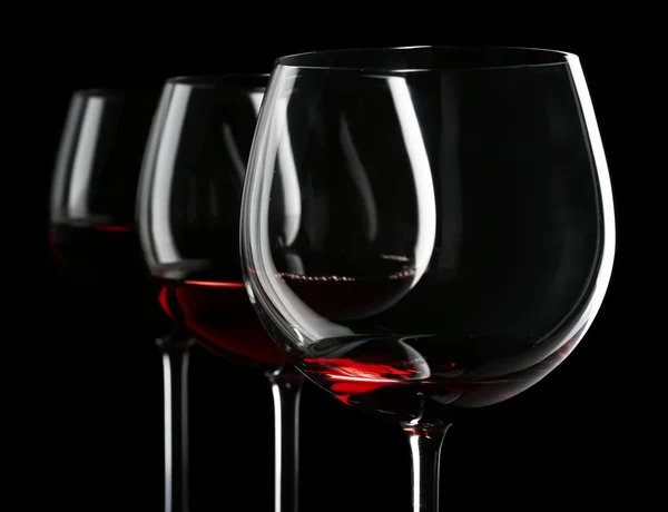 Glasses of wine on black — Stock Photo, Image