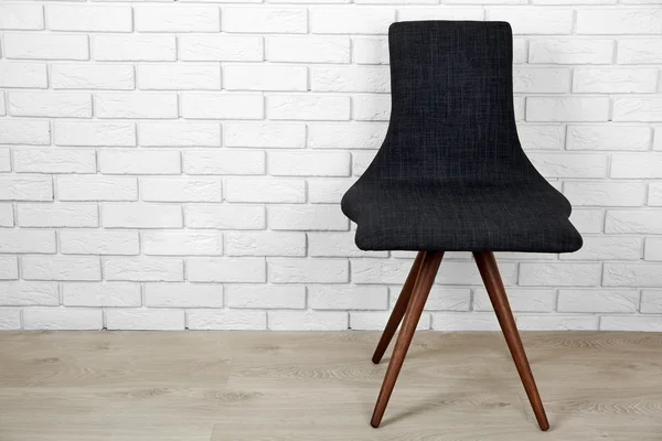 Modern chair on brick wall background — Stock Photo, Image