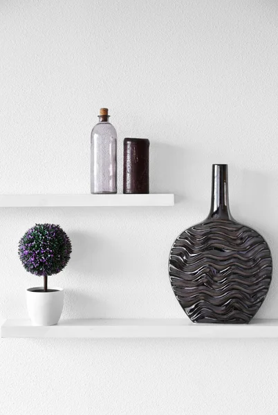 Decorative vases on wooden shelves — Stock Photo, Image