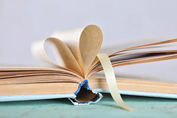 Pages of book curved into heart shape — Stock Photo, Image