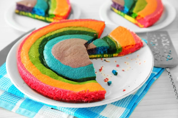 Läckra rainbow cake på plattan, på ljus bakgrund — Stockfoto