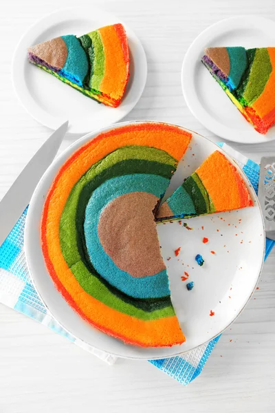 Deliziosa torta arcobaleno sul piatto, su sfondo chiaro — Foto Stock