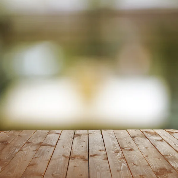 Dřevěný stůl s abstraktní rozostření pozadí — Stock fotografie