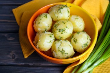 Masada bir kapta yeşillikleri ile haşlanmış patates yakın çekim