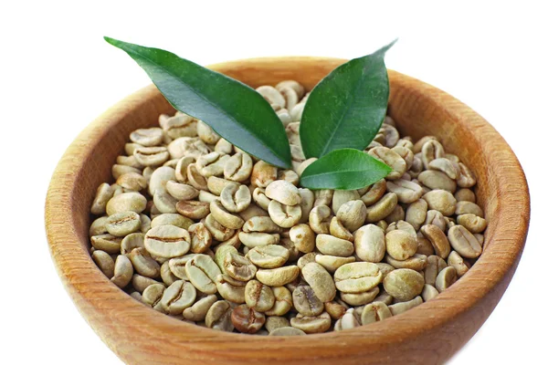 Green coffee beans with leaves in bowl close up — Stock Photo, Image