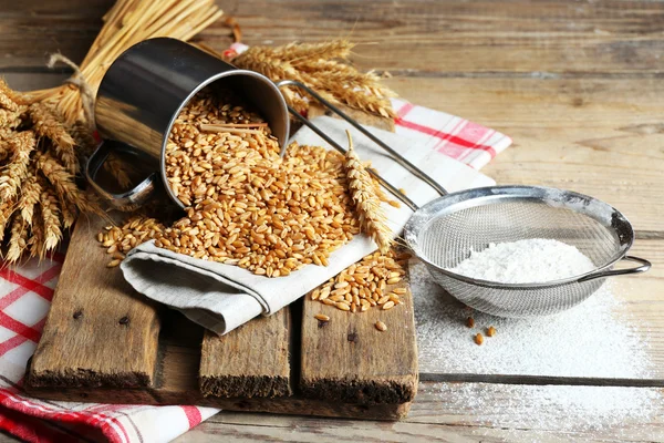 Flour and wheat on wooden table, closeup — Stock Photo, Image